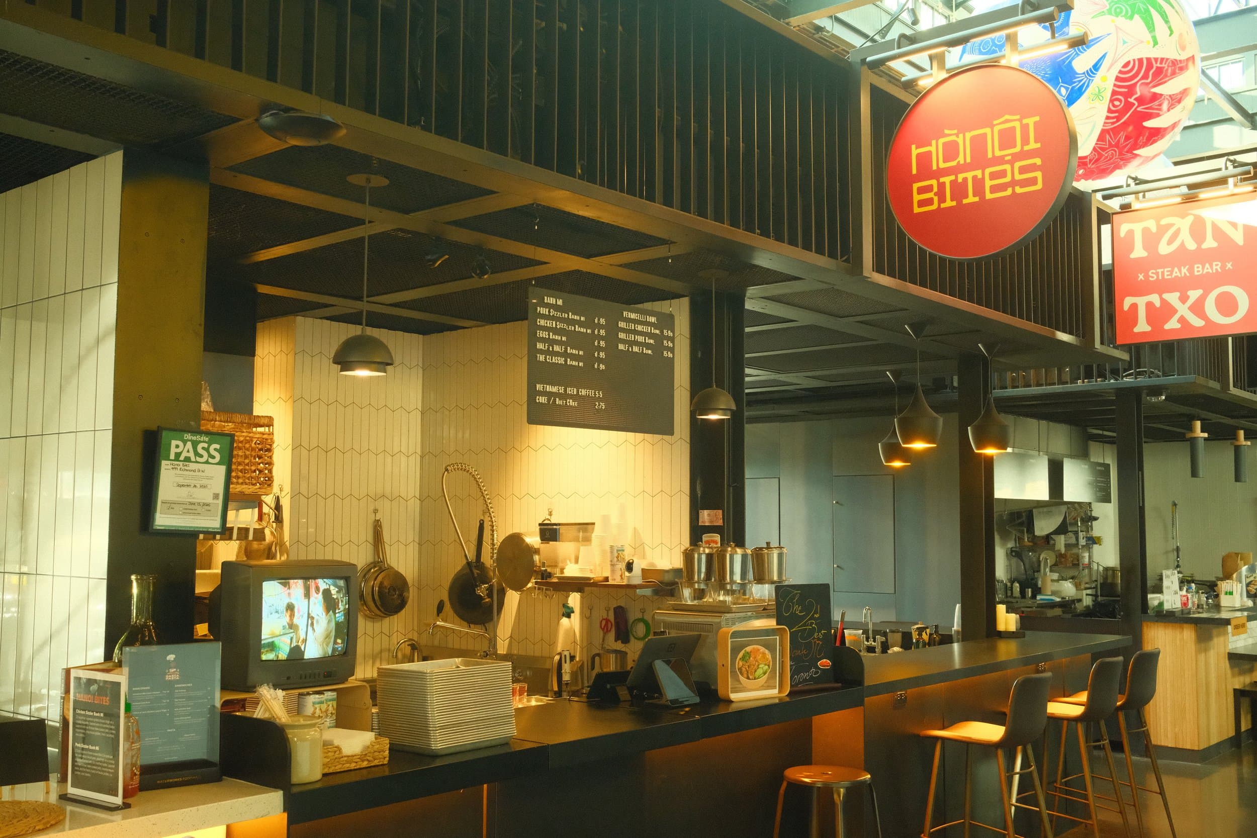 Interior of a casual restaurant or cafe with a Hanoi Bites sign